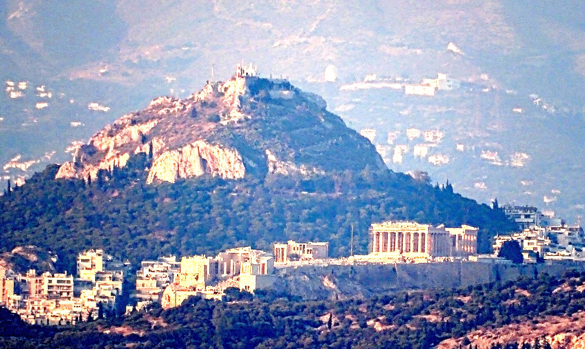 The Acropolis and Lycabettus Hill seen from the sea off Piraeus, showing the distance between the port and central Athens